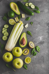 Set of green fruits and vegetables on grey background.Top view.