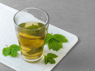 Green tea with lemon in a transparent glass