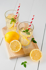 Fresh citrus lemonade in the glasses,wooden white background