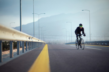 Bicycle rider on the high way