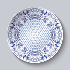 Dish painted with blue national patterns in the style of painting on porcelain isolated on gray.