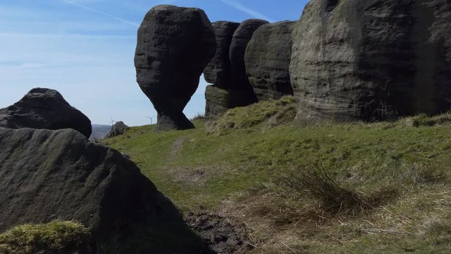 Handheld camera shot of natural wonder, the Great Bridestones in North Yorkshire near Todmorden, England, UK. Natural sculpture of the Bride and fallen Groom to her left.