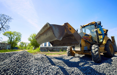 Laying rubble on the road with a heavy excavator.