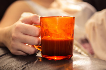 Holding a cup of coffee with milk