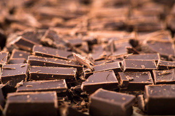 Stack of chocolate slices with mint leaf. dark chocolate over wooden background, selective focus