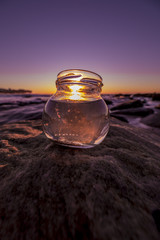 Glass jar in front of the sunset