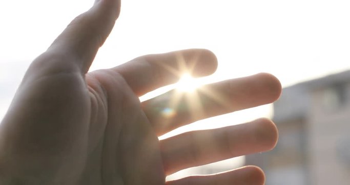 Hand raised up to the sun, sunbeam sunny sunrise concept reach playing sunlight ray touch freedom joy inspiration sunset bright flare close up sky god human hope summer peace religion 4k