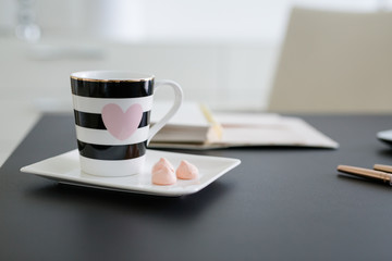 Coffee cup with pink heart and sweets