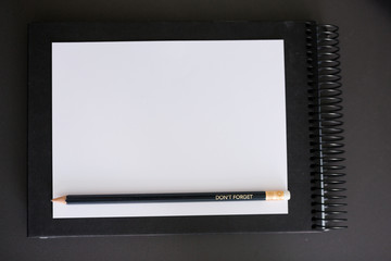 Don't forget - Blank paper with message on pen