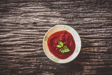 tomato sauce and tomatoes on wooden background