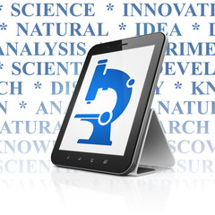 Science concept: Tablet Computer with Microscope on display