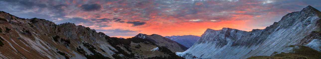 Fototapeta na wymiar Burning sunrise over mountains panorama