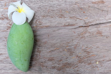 Green mango on the table with wooden background