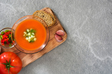 Traditional Spanish cold gazpacho soup on gray stone.
