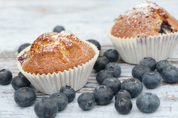 Muffin and blueberries on wood