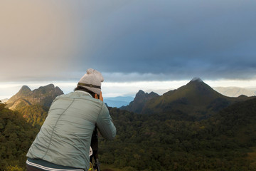 Photographer takes photo on the mountain.