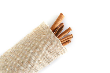 Cinnamon stick in sack isolated on white background