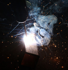 Sparks and jets of smoke when welding