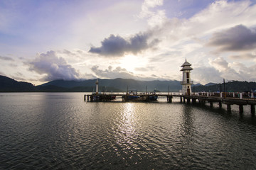 Obraz premium Morning Harbor with views of mountains and clouds.