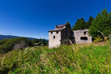 An Old Stone House In A field