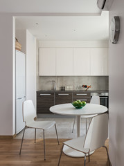 Interior of modern apartment in scandinavian style with kitchen and workplace.