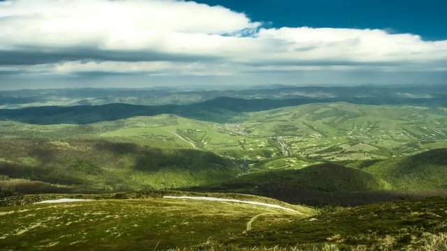 Summer landscape in mountains and dark blue sky. The clouds fly over the mountains and cast a shadow over the mountain Time lapse. High quality Footage - Original Size 4k.