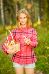 Teen girl with basket of mushrooms showing honey agaric