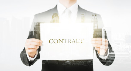 close up of businessman holding contract paper