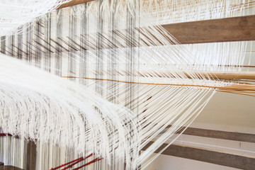 old weaving Loom and thread of yarn.