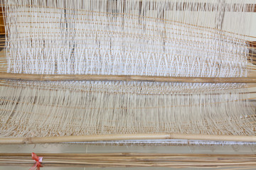 old weaving Loom and thread of yarn.