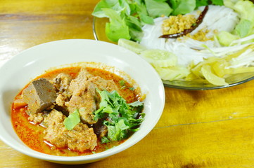 rice noodles and fresh vegetable eat with spicy chop pork and bone red cotton tree sauce