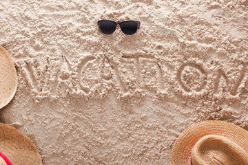Fototapeta na wymiar vacation written in a sandy tropical beach
