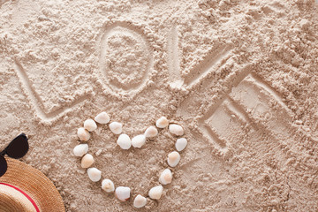 Fototapeta na wymiar Love written in a sandy tropical beach