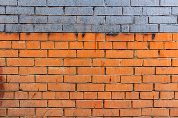 Old brick wall with blue stripe and dirty spots. Abstract background