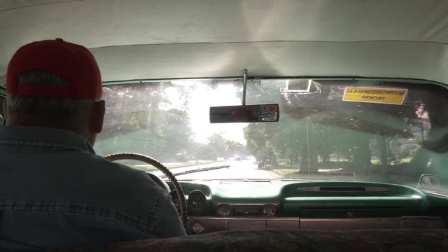 Man Driving Vintage 50's Car in Cub