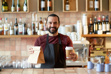 man or waiter with coffee and paper bag at bar