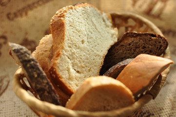 Assorted sliced bread in a wicker basket.