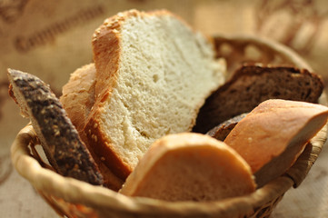 Assorted sliced bread in a wicker basket.