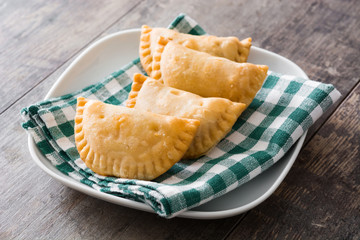 Typical Spanish empanadas on wooden table
