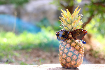Pineapple with sunglasses, summer concept.
