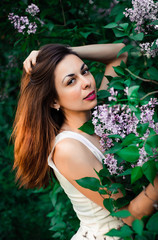  Young girl in complete tranquility and pacification in a beautiful and elegant dress on nature in the spring in the park