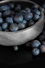 Blueberries in a wooden bowl.  Selective colour