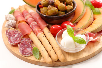 antipasti with melon, salami and olive