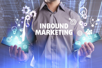 Business, Technology, Internet and network concept. Young businessman working on a virtual screen of the future and sees the inscription: Inbound marketing