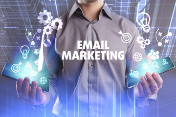 Business, Technology, Internet and network concept. Young businessman working on a virtual screen of the future and sees the inscription: Email marketing