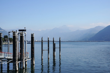relax view of jetty, dock with birds in blue lake summer vacation