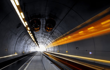 Traffic rushing through a modern tunnel. Traffic concept