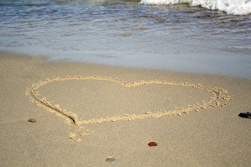 Heart on beach. Romantic composition.