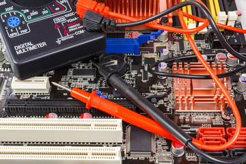 Probes with digital multimeter on the motherboard surface