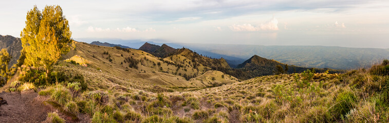 Fototapeta na wymiar Panoramic view of the hills and coastline from the top of caldera Rinjani 